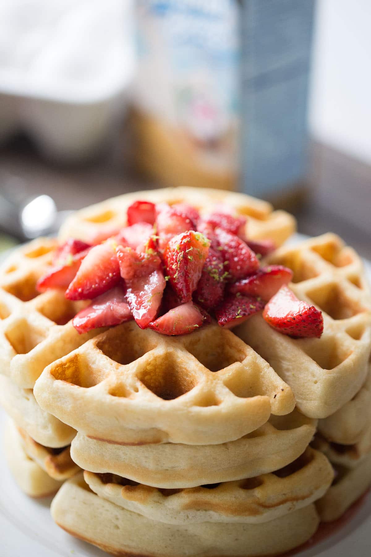 This key lime Belgian waffle recipe with it's fresh strawberry sauce are perfect for special occasions or lazy mornings!