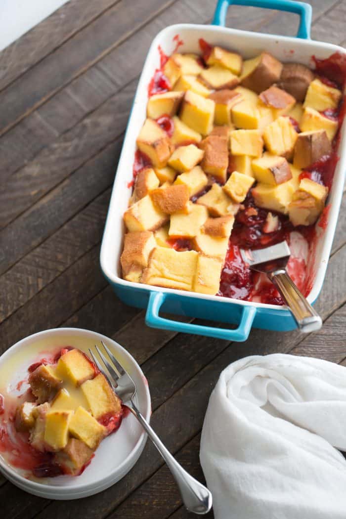 Strawberry rhubarb pie filling is topped with pound cake and baked in a custard sauce. A vanilla glaze is drizzled over top this easy dessert recipe! 