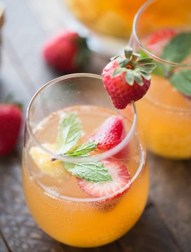 This mango sangria is so refreshing! Sweet mangos and strawberries are combined with a light wine and vodka to bring you a little taste of summer in a glass!