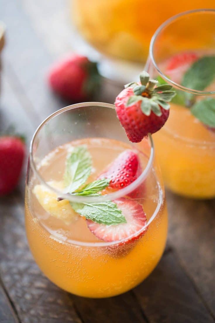 This mango sangria is so refreshing! Sweet mangos and strawberries are combined with a light wine and vodka to bring you a little taste of summer in a glass!