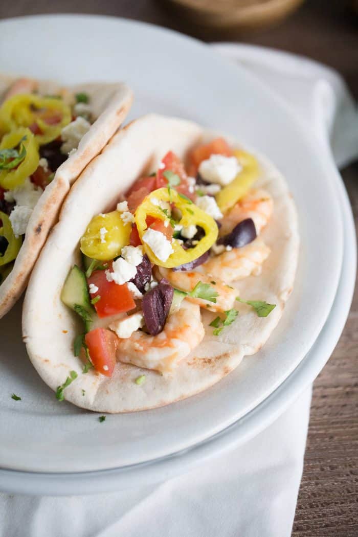 This gyro sandwich is a little different. Creamy, garlic shrimp is placed inside pita rounds them topped with fresh vegetables, feta and a homemade tzatziki sauce!
