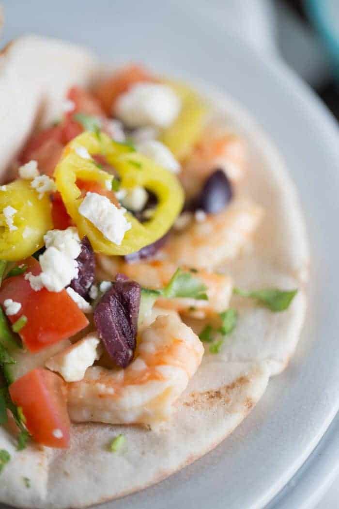 This gyro sandwich is a little different. Creamy, garlic shrimp is placed inside pita rounds them topped with fresh vegetables, feta and a homemade tzatziki sauce!