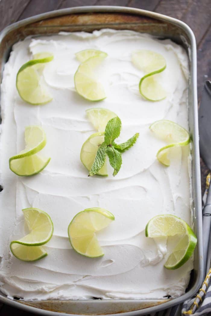 Mojito meets cake in this simple dessert recipe! A rum flling is soaked into fluffy white cake and then topped with a minty buttercream frosting! 