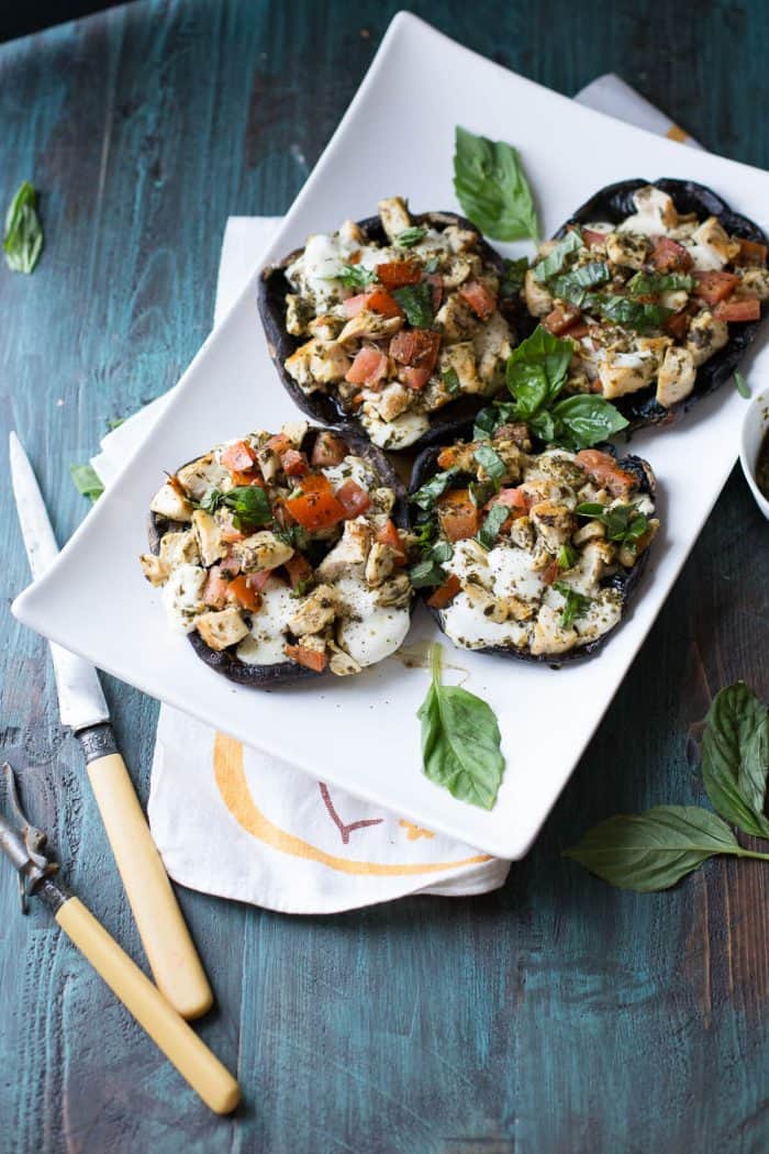 Caprese chicken; pesto coated chicken, juicy tomatoes and soft, fresh mozzarella cheese are stuffed into tender portobello mushroom caps then lightly broiled. Homemade pesto is the key to flavor!