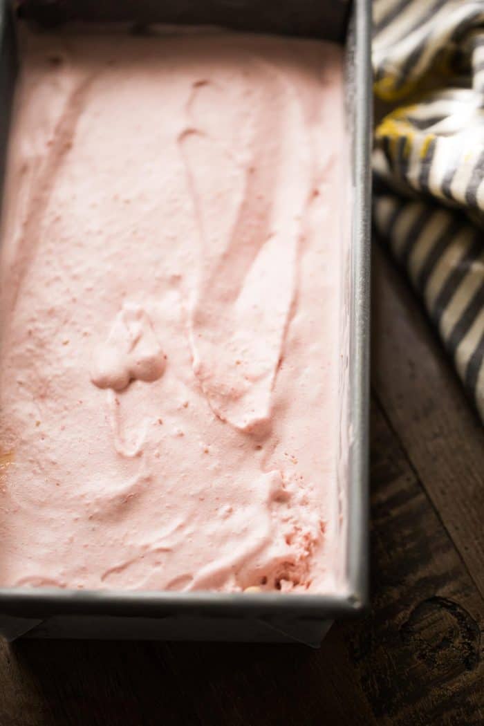 Bold raspberry ice cream in a cake pan.
