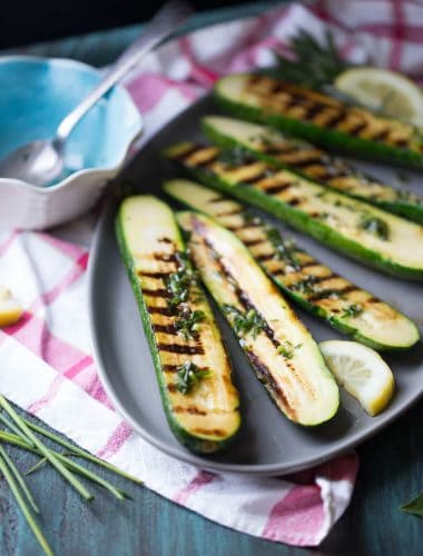 Grilled zucchini is drizzled with fresh herbs and butter for a satisfying side dish that everyone will love!