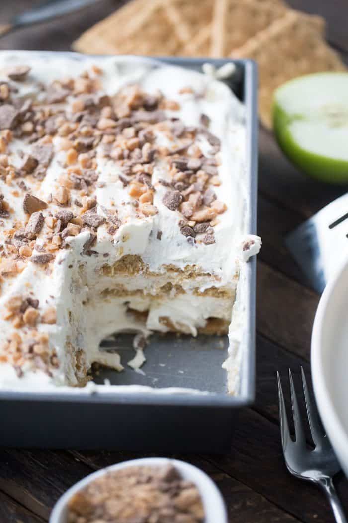 This eclair cake is like apple pie but better! Graham crackers are the "cake" layers that are held in place with apple pie filling and apple spiced pudding. Toffee bits crown the top!