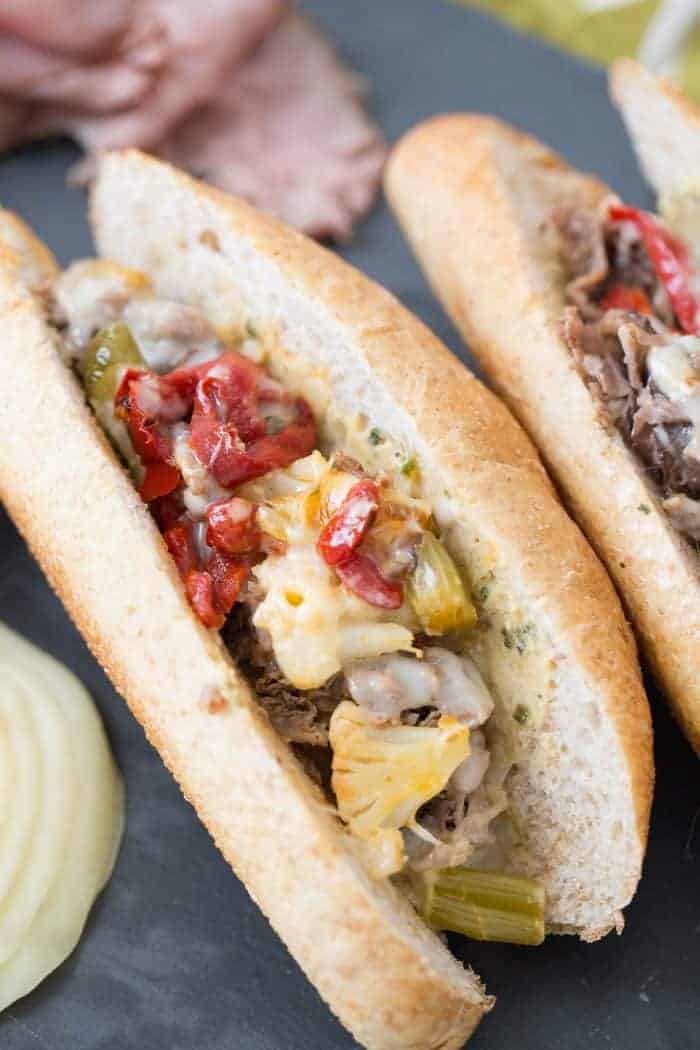 Nothing beats a good cheesesteak sandwich! This Italian version has pickled vegetables, roasted red peppers, provolone and a hummus garlic herb spread!