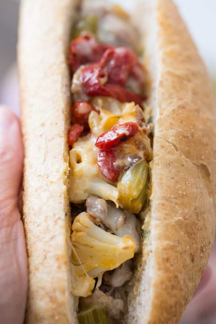 Nothing beats a good cheesesteak sandwich! This Italian version has pickled vegetables, roasted red peppers, provolone and a hummus garlic herb spread!