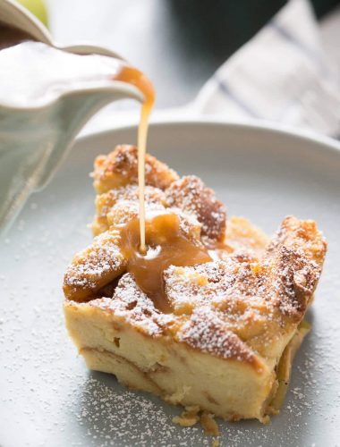 Tender sweet bread and cinnamon apples makes this bread pudding recipe taste amazing! The caramel sauce on top is the crowning glory!