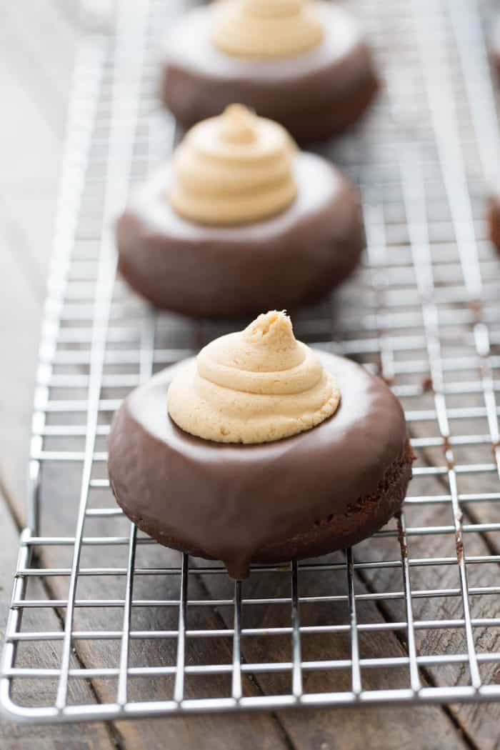 Donuts turn into cakes in this recipe! Buckeye mini cakes are donuts filled with peanut butter frosting to look and taste like the buckeye candy.
