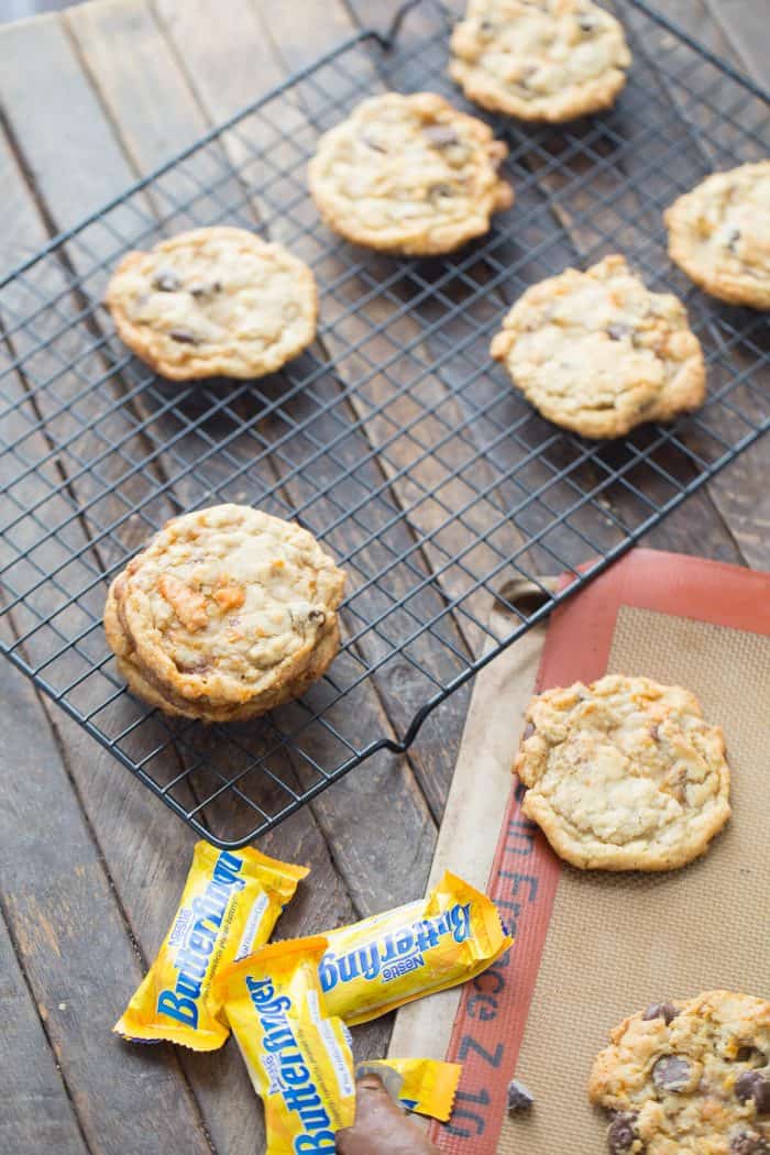 Six homemade Butterfinger cookies on a cooling rack.