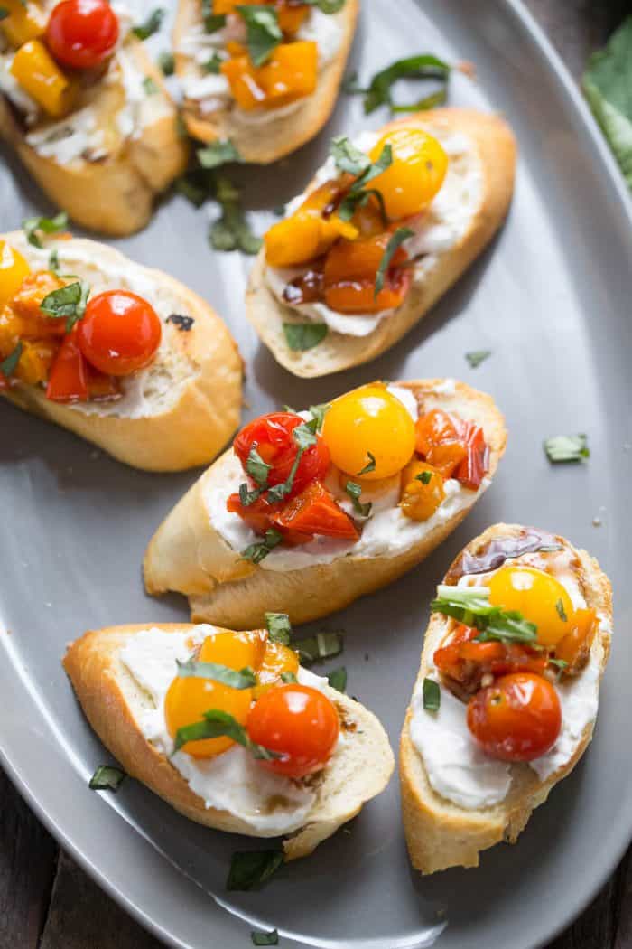 This bruschetta recipe looks so impressive with the colorful roasted veggies and creamy whipped feta!