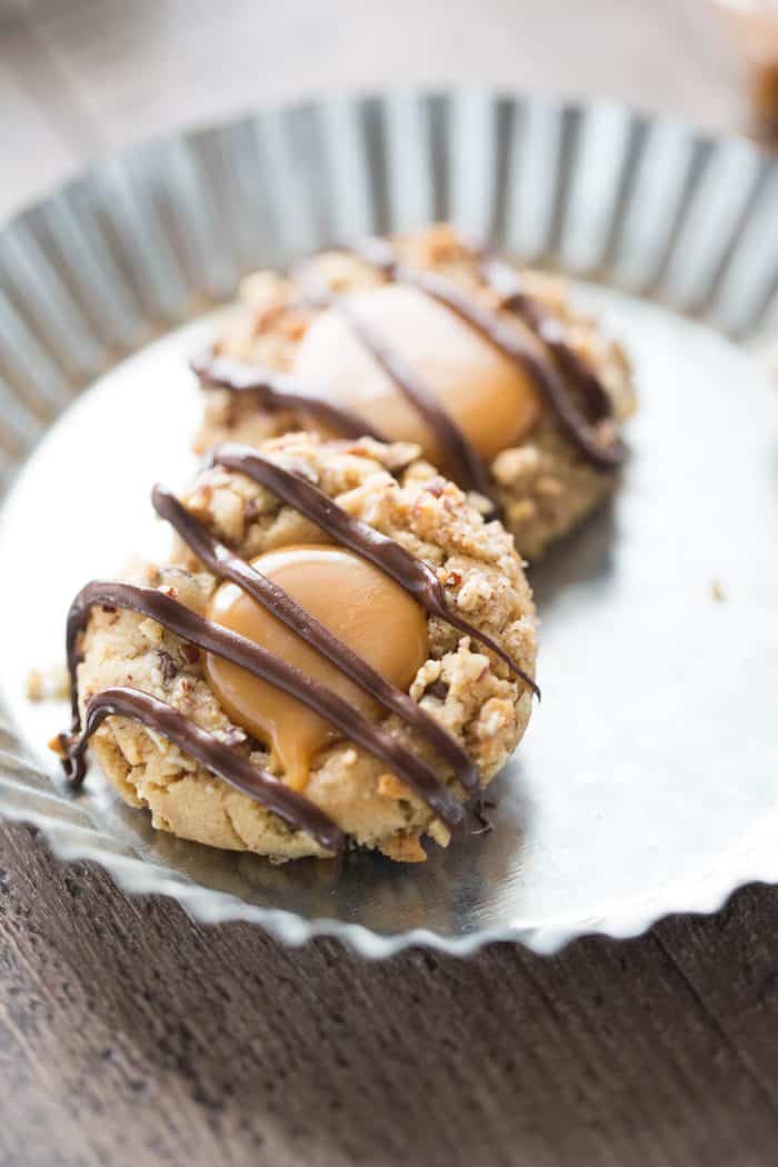 These thumbprints look ordinary but they are hiding mini chocolate chips in a peanut butter batter! Caramel and chocolate make them extra special!