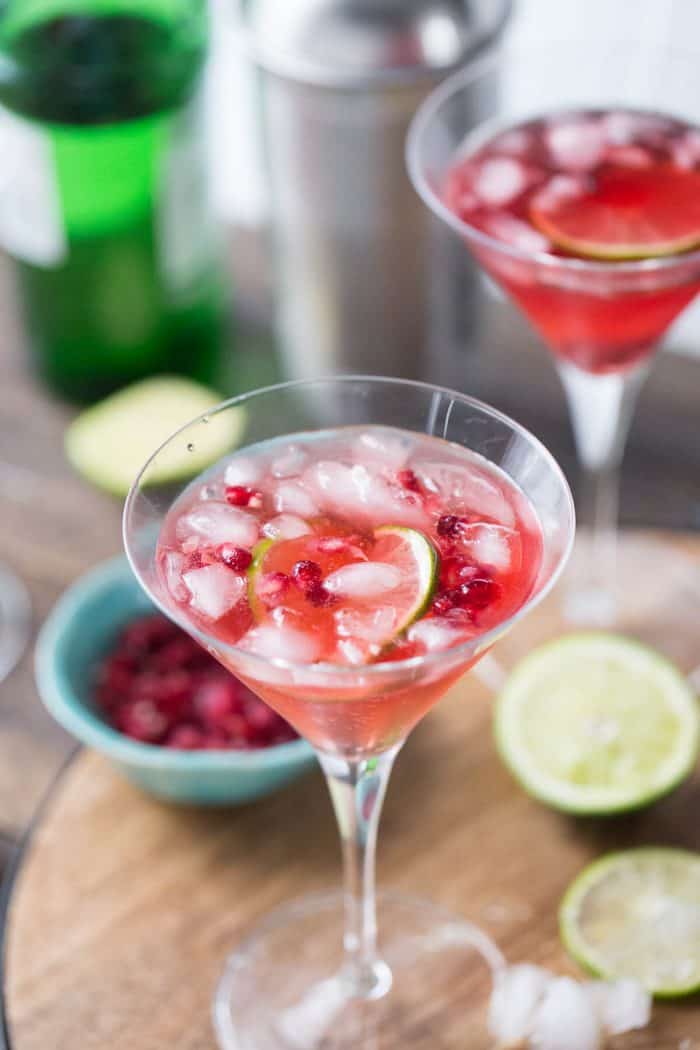This gin fizz is festive and fun! Fresh pomegranate seeds and limes are perfect together!