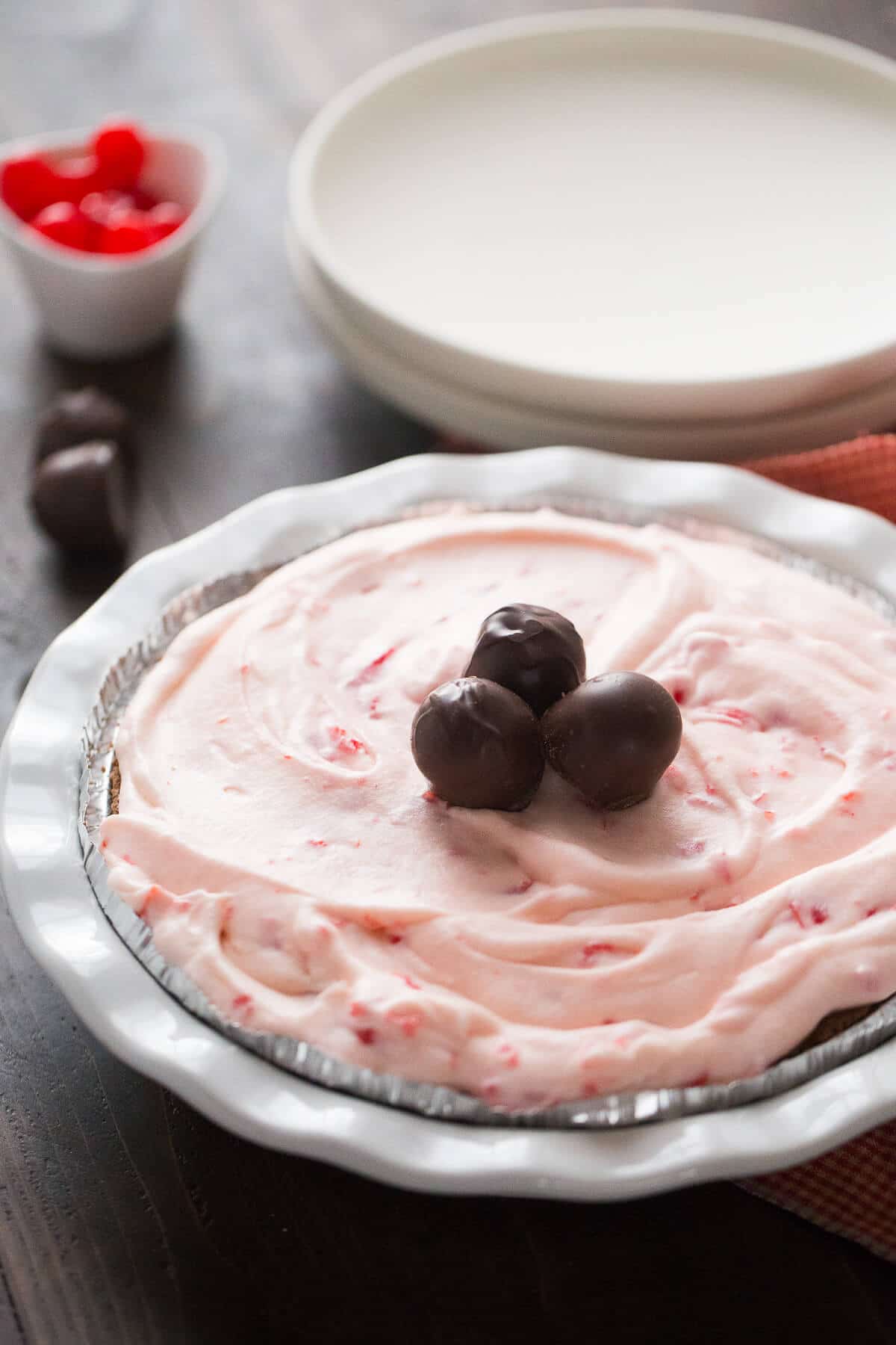 This cherry cream pie is dreamy! It is light and fluffy and hides a rich chocolate layer!