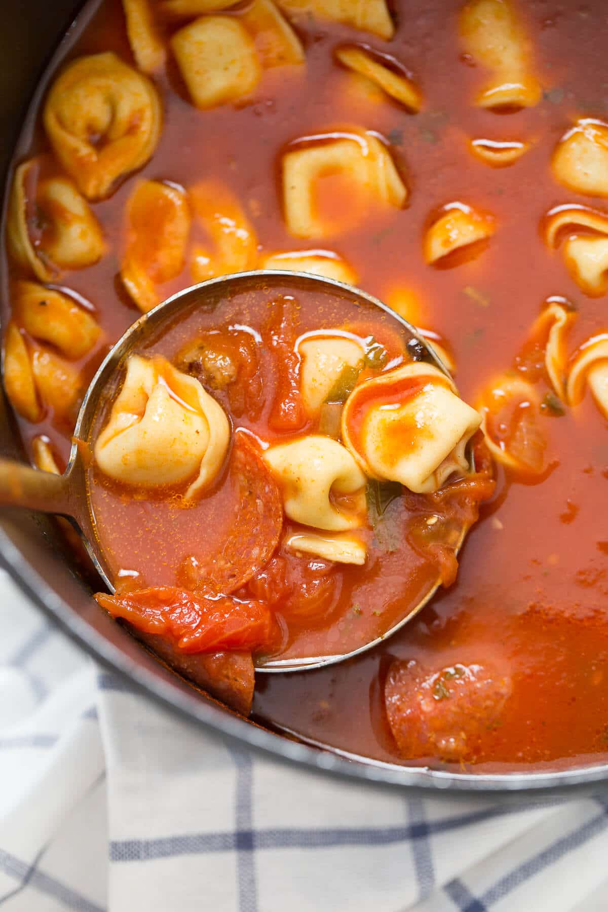 This pizza soup is filled with so much goodness and topped with a fun puff pastry "crust"!