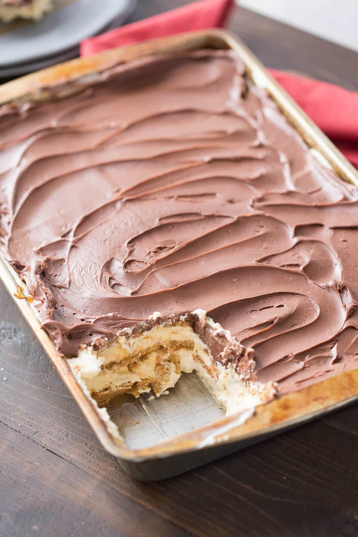 eclair cake in a pan with a piece missing