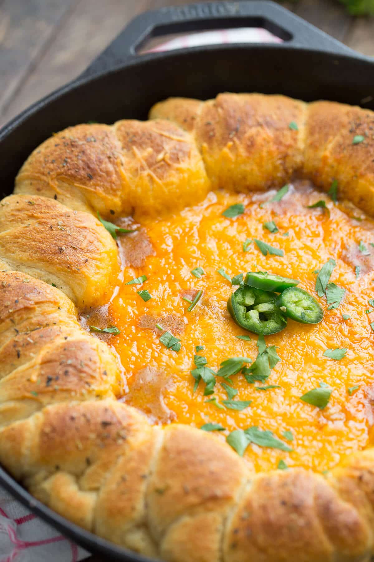 Hosting? Then you need this chili cheese dip! The skillet cooks it up nice and hot and the rolls make scooping a breeze!