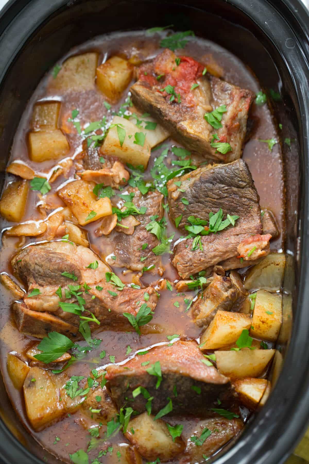 Slow cooker short ribs are resting in Guinness infused broth!  How can you say no?