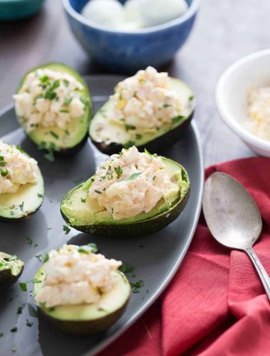 This deviled avocado takes deviled eggs to a whole new level! Seasoned egg salad is nestled into the center of avocados for a light lunch or snack!