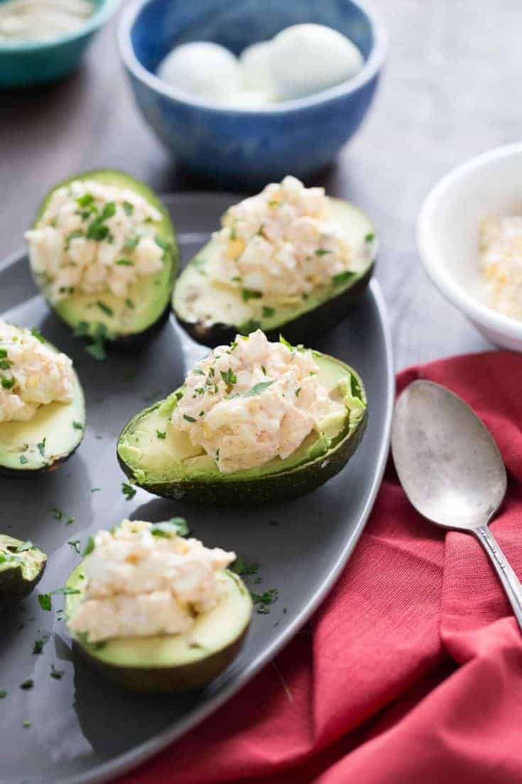 This deviled avocado takes deviled eggs to a whole new level! Seasoned egg salad is nestled into the center of avocados for a light lunch or snack!