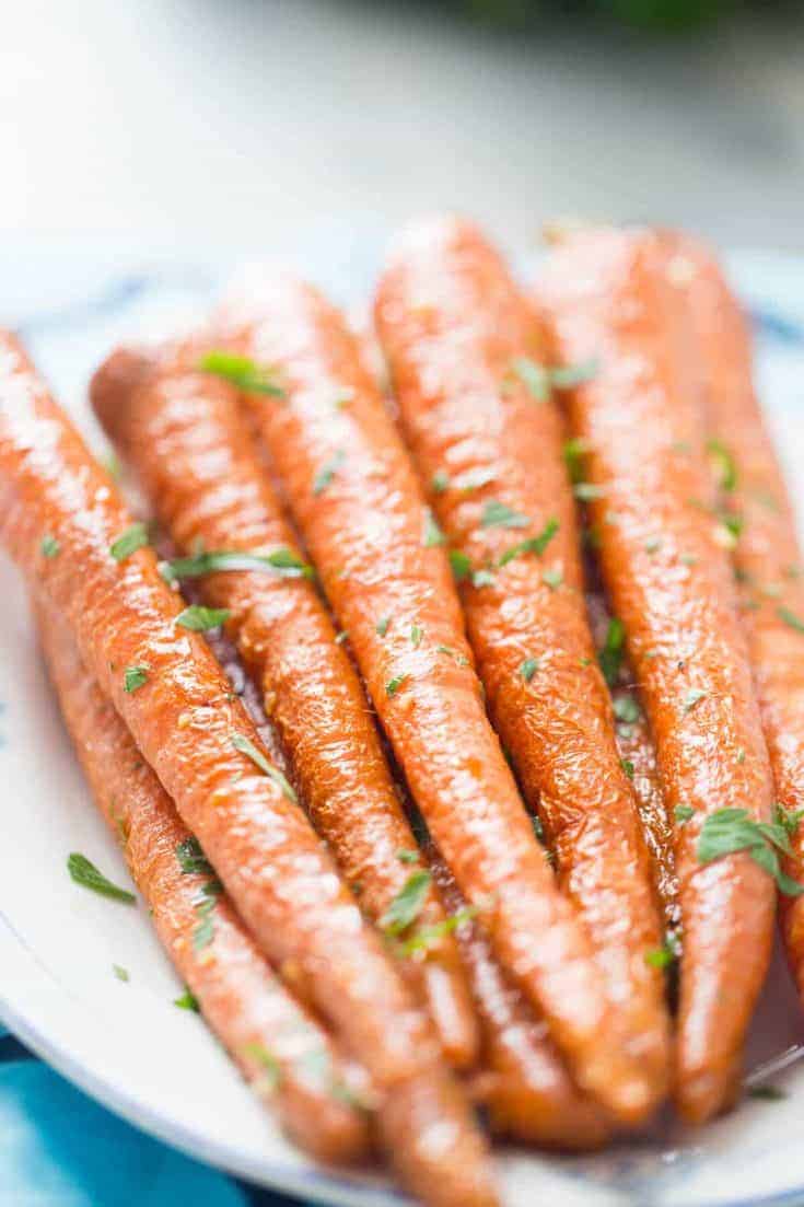 Oven roasted carrots coated in garlic and parsley are simple and delicious! You are going to love them!