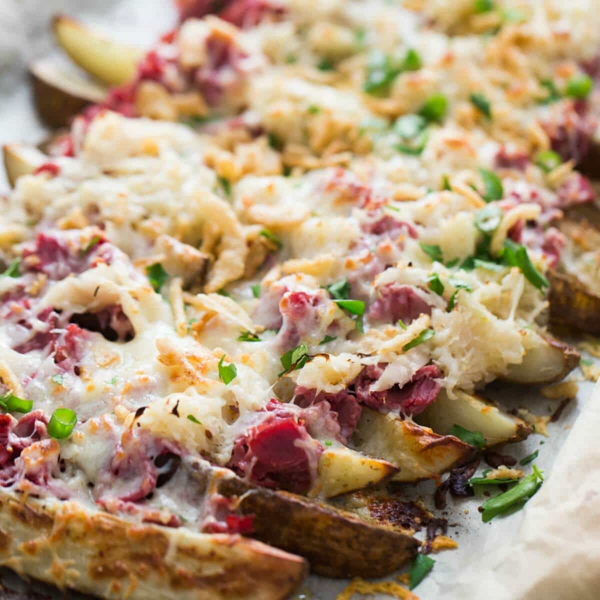 This loaded potatoes recipe is so good! Classic reuben ingredients are a piled high on top of crispy potato wedges!