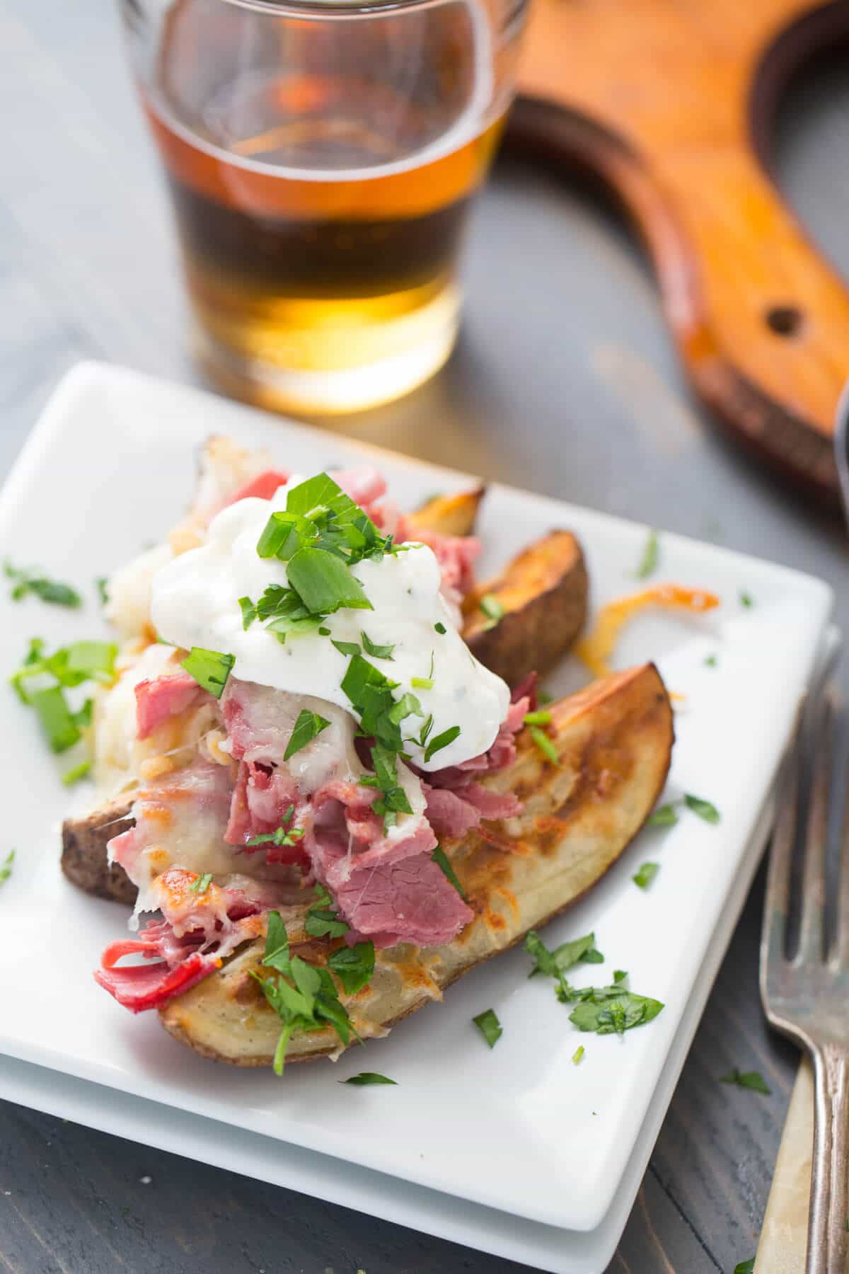 Loaded potatoes recipe the is topped with corned beef, kraut, cheeses and crispy onions! Absolutely delicious!
