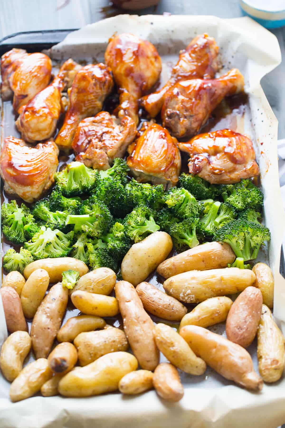 This sheet pan dinner is fantastic! This bourbon chicken recipe is baked with potatoes and broccoli then basted with a bourbon glaze!