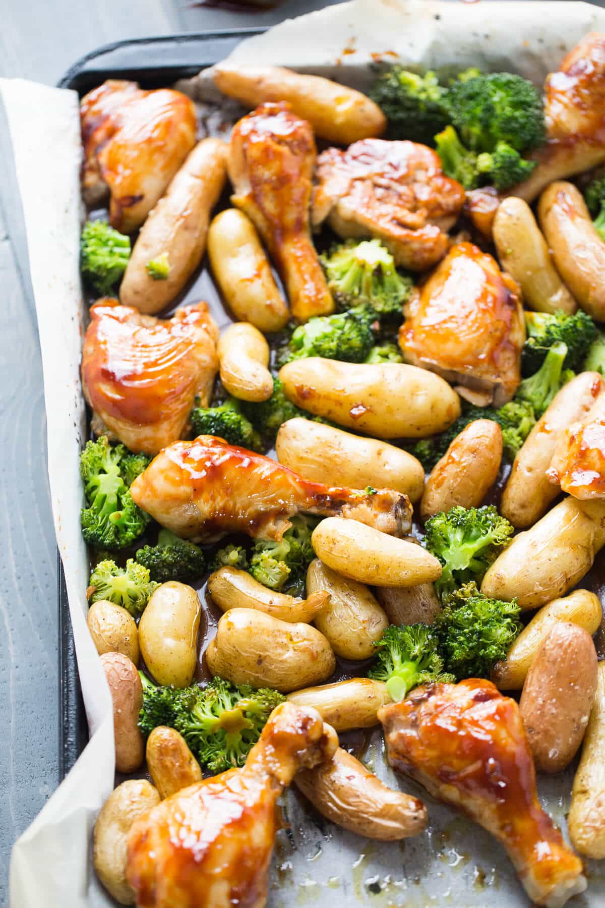 A sheet pan dinner is so easy! Bourbon Chicken is baked and tossed with potatoes and broccoli. The bourbon sauce is subtly sweet and coats each piece perfectly!