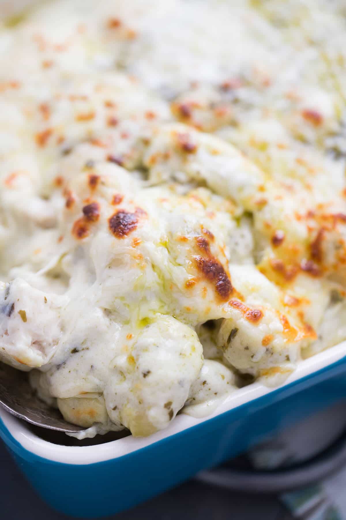 This easy gnocchi recipe has three kinds of cheese, pesto and chicken! It is the perfect meal! lemonsforlulu.com