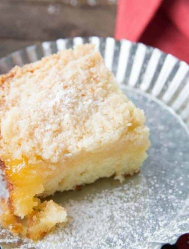 This tender crumb cake is so fluffy and moist! It has a tart lemon curd layer and a buttery crumb topping!