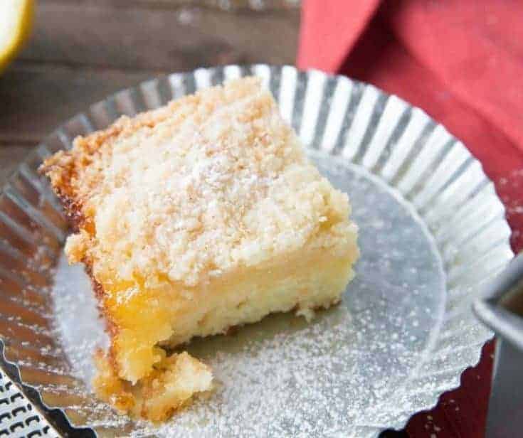This tender crumb cake is so fluffy and moist! It has a tart lemon curd layer and a buttery crumb topping!