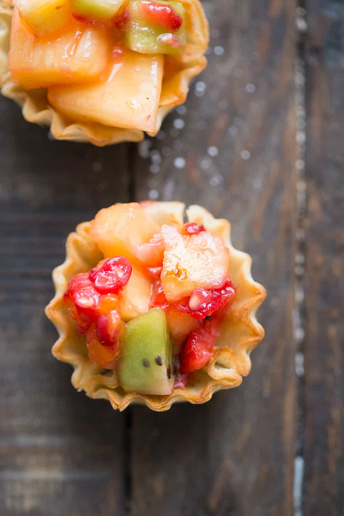 Fruit salsa is a hit at any party. These little shells are coated in cinnamon sugar and filled with a tropical fruit combination that is amazing!