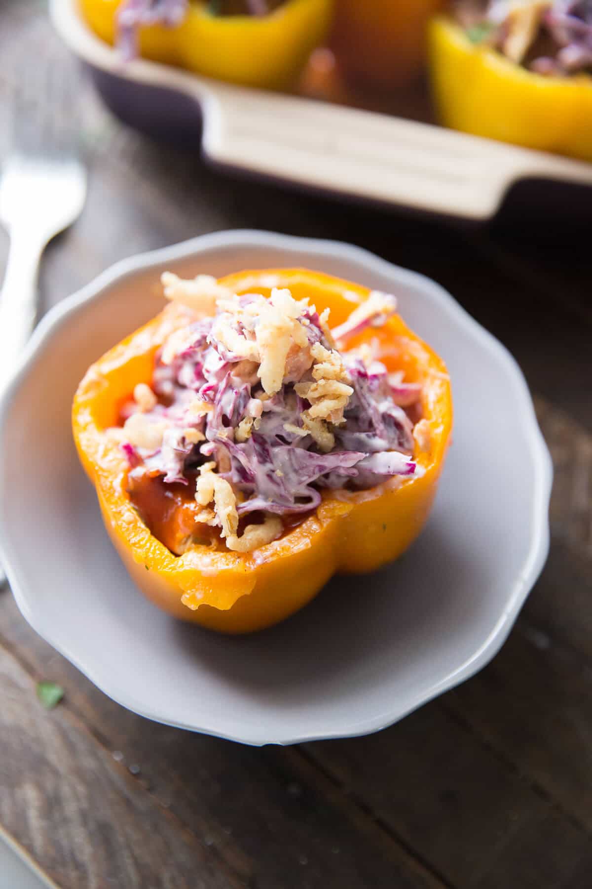 Southwest Stuffed peppers are filled with BBQ brisket and topped with a tangy slaw! The colors and the flavor pop!