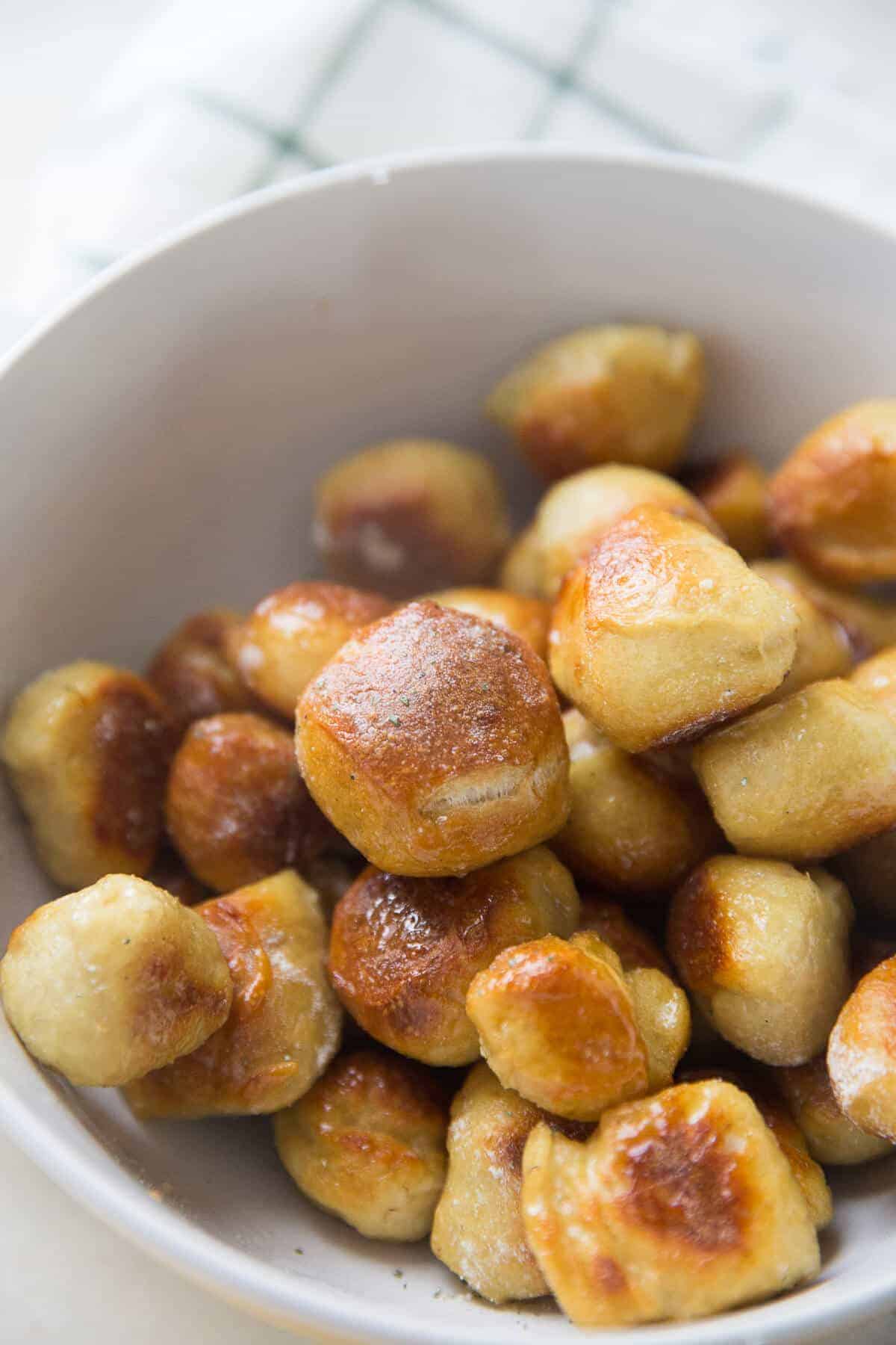 Soft pretzel bites are coated in melted butter and ranch seasoning for the perfect snack! Don't forget he Buffalo sauce!