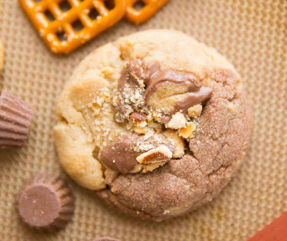 Chocolate and peanut butter are swirled together in these Chocolate Peanut Butter Explosion Cookies! Peanut butter cups, peanut butter chips all make an appearance as do pretzels which add a little saltiness to the sweet mix!