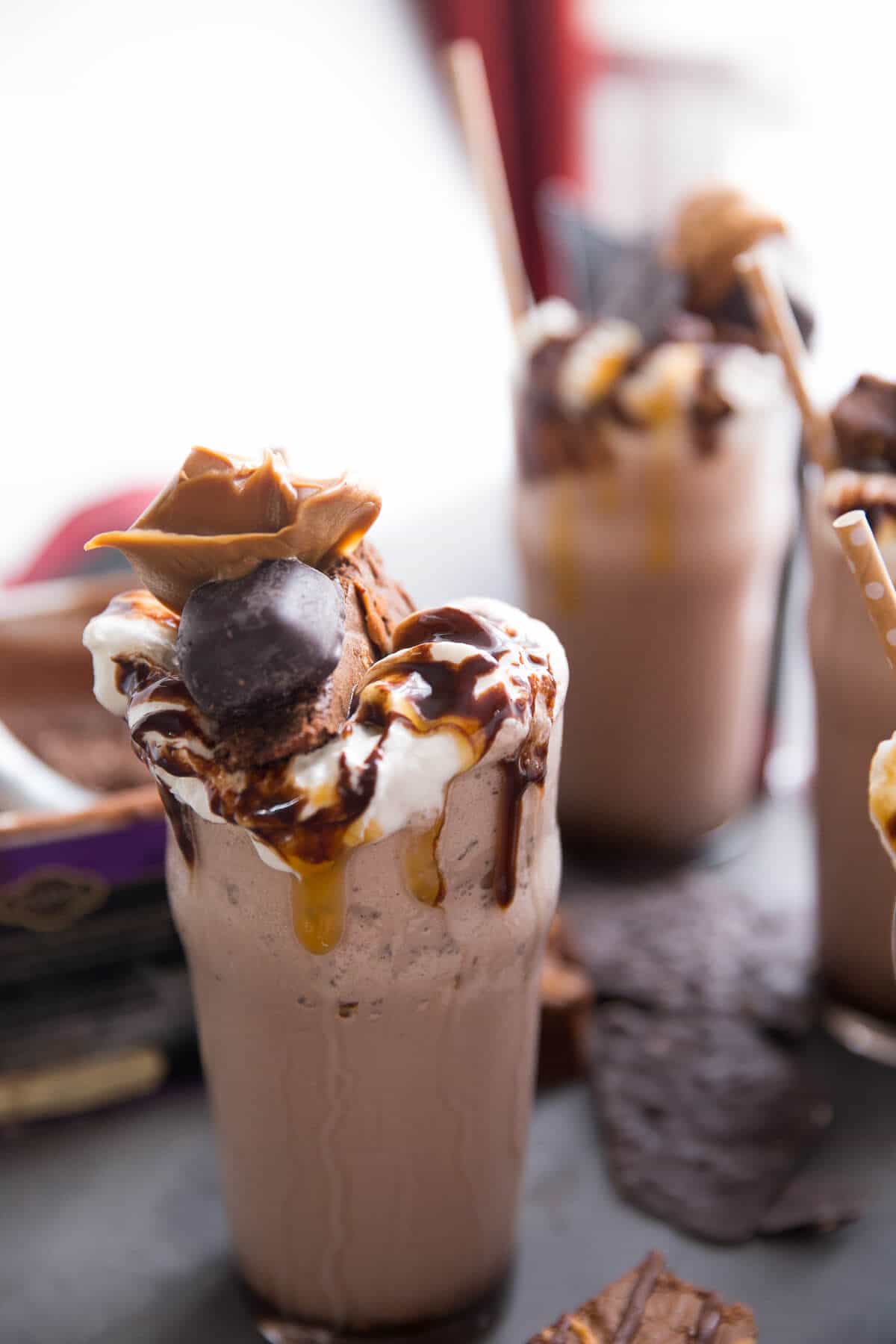 This salted caramel milkshake is for extreme salted caramel lovers! Brownies, candies, salted caramel sauce, and two kinds of ice creams make this one memorable and extreme milkshake!
