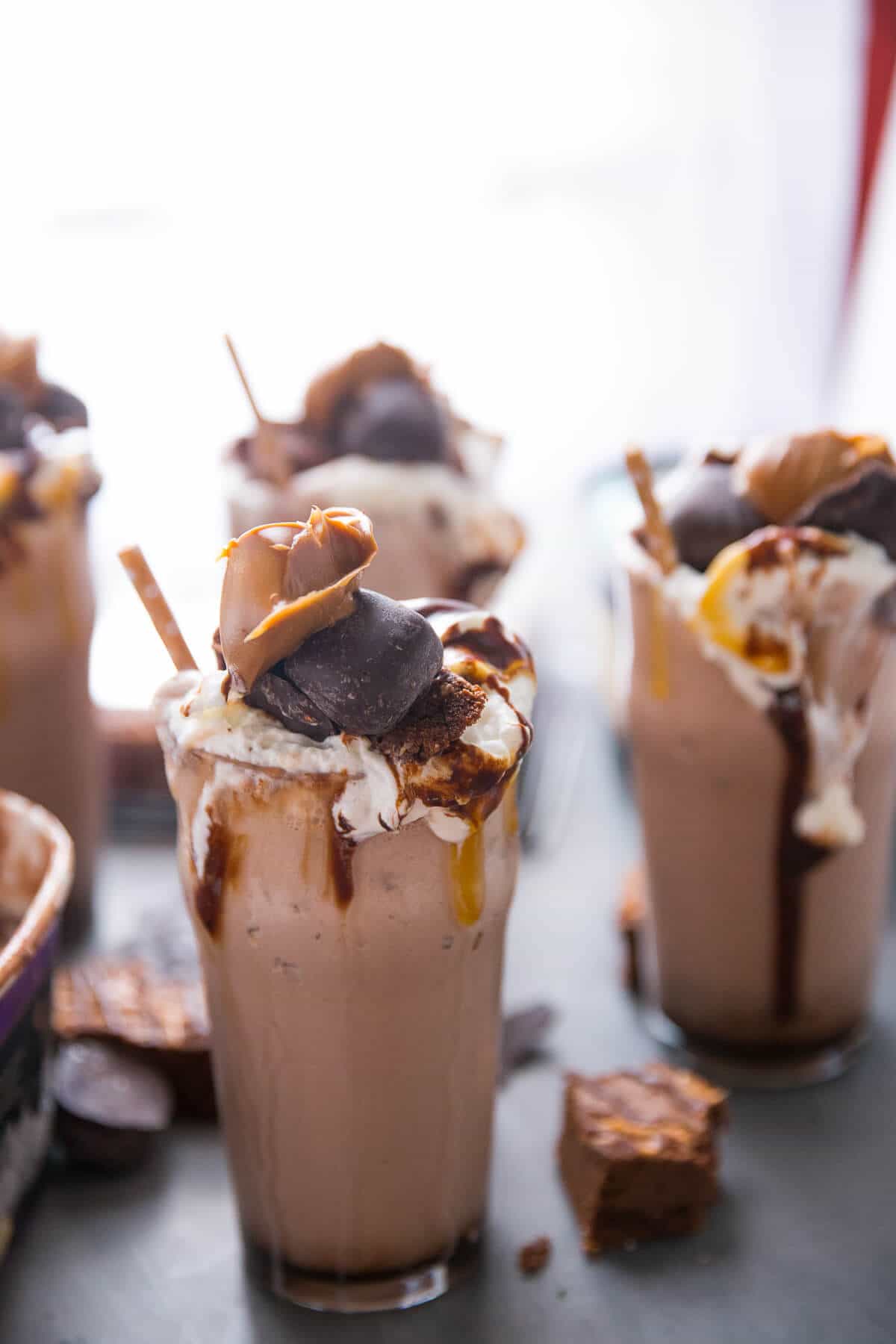 This salted caramel milkshake is for extreme salted caramel lovers! Brownies, candies, salted caramel sauce, and two kinds of ice creams make this one memorable and extreme milkshake!
