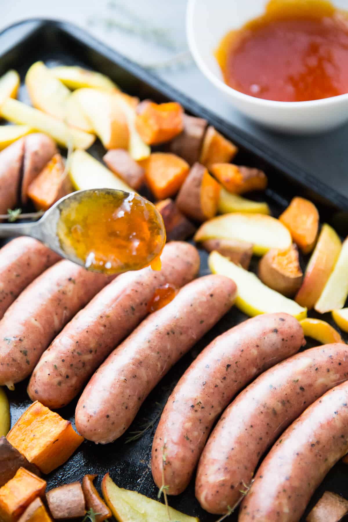 This sheet pan sausage dinner is inspired by the flavors of fall.  Cheesy sausage is baked along side sweet potatoes, apples and a simple apricot glaze!
