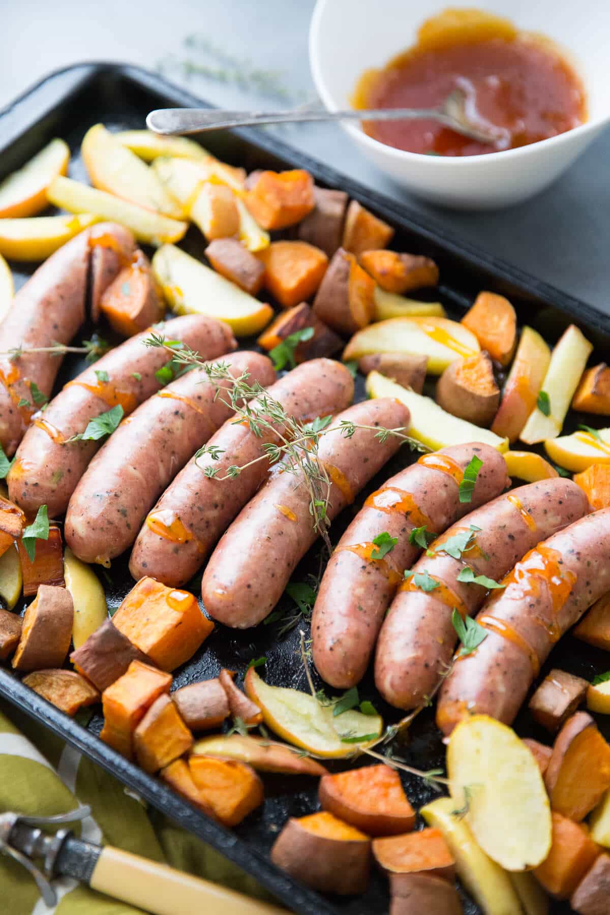 This sheet pan sausage dinner is inspired by the flavors of fall.  Cheesy sausage is baked along side sweet potatoes, apples and a simple apricot glaze!