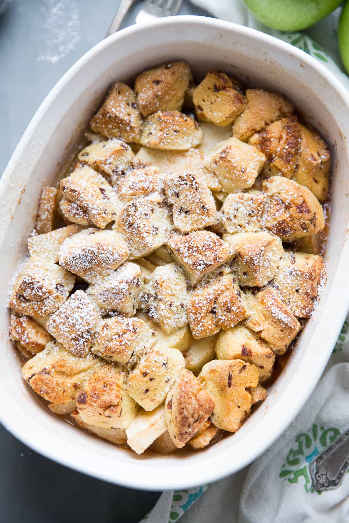 This easy apple cobbler recipe is fabulous! Tart apples, cinnamon, and sugar make the perfect apple base.  Store bought cinnamon rolls make an unforgettably delicious topping!