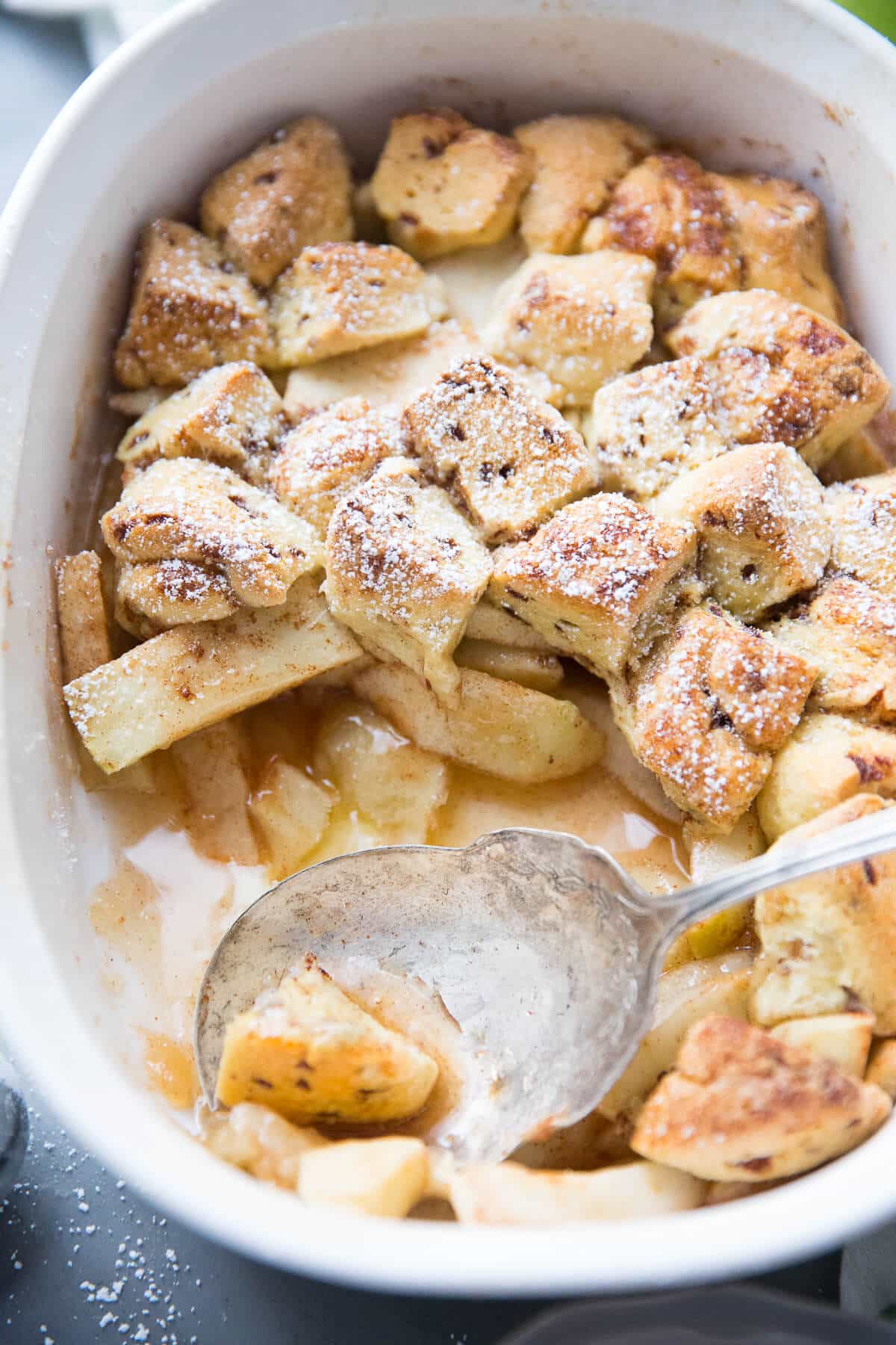This easy apple cobbler recipe is fabulous! Tart apples, cinnamon, and sugar make the perfect apple base.  Store bought cinnamon rolls make an unforgettably delicious topping!