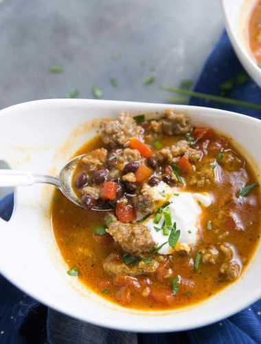 This black bean chili has a little something special; pumpkin!  This easy chili is filled with black beans, Italian sausage, spices, and pumpkin. This filling black bean chili is just what you need when you need a little warming!