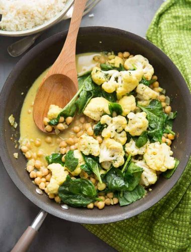 It's easy going meatless with this easy Vegetarian Curry.  Cauliflower, garbanzo beans, and spinach are cooked in a coconut sauce that is rich and silky!