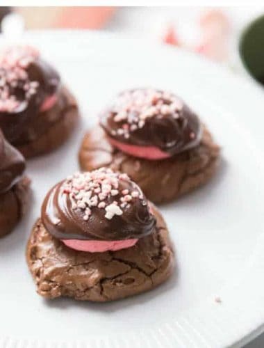 Four delicious chocolate peppermint cookies on a large white serving plate.