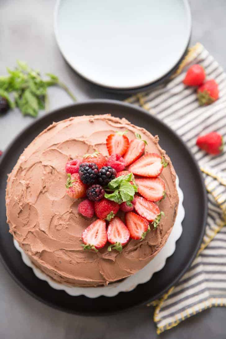 Whole chocolate cake with fruit on top