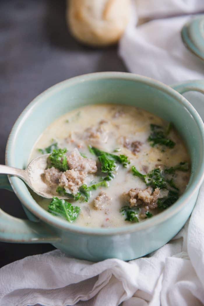Sausage and kale soup with spoon