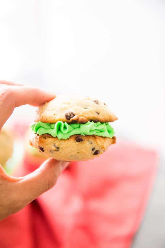 Fingers holding mint chocolate chip whoopie pie
